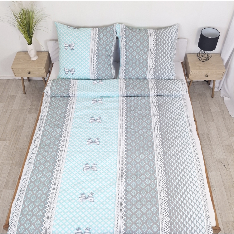 Pościel z Kory PREMIUM Lilia Wytrzymała- Turkusowe kokardki 1077, rozłożona na łóżku